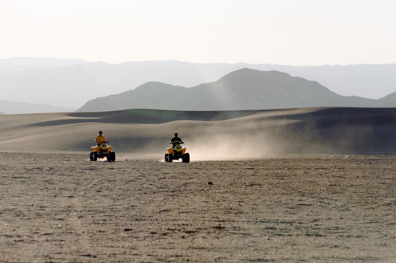 two-people-riding-atv-on-desert-2986409